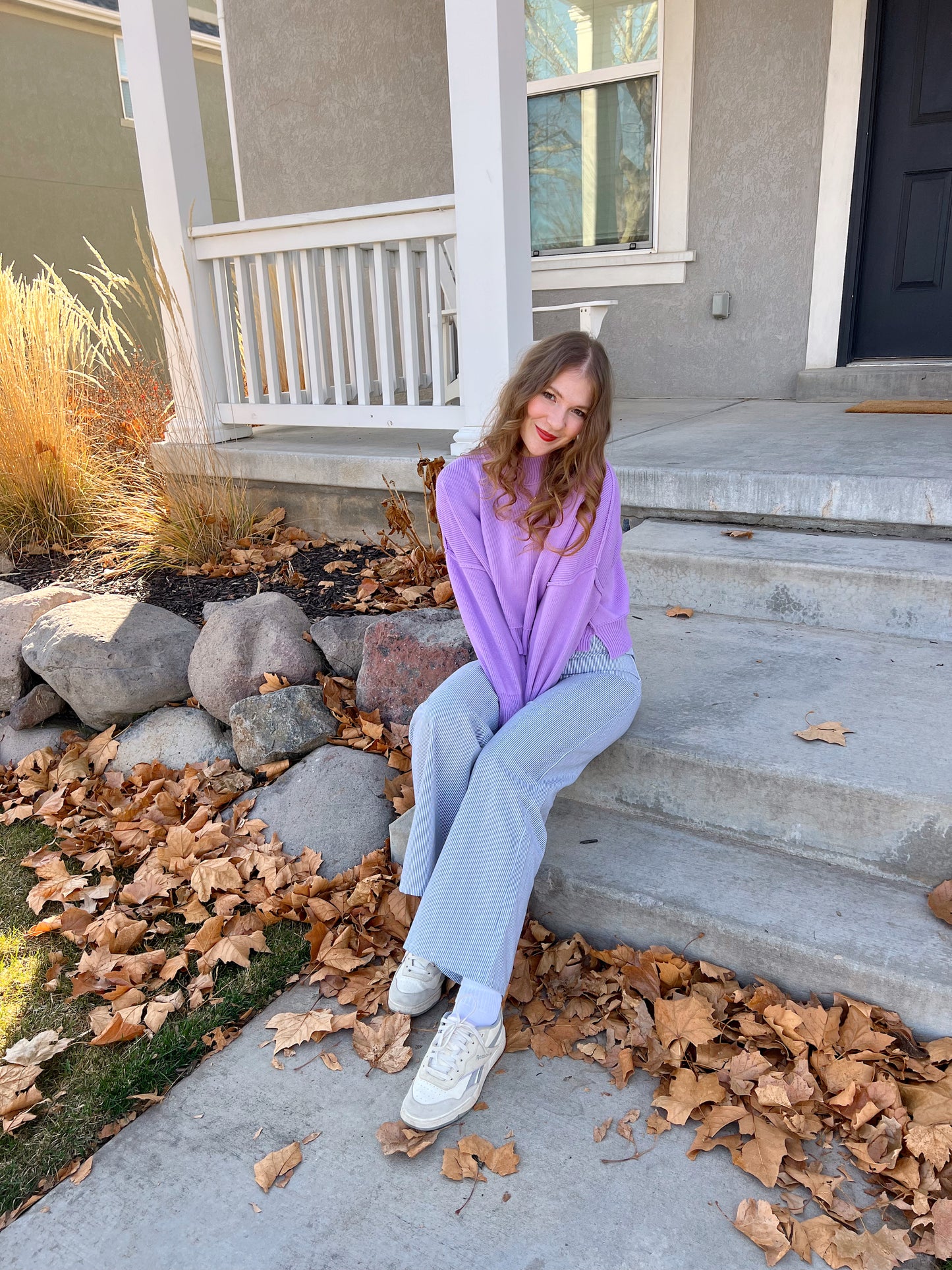 sitting on a bench in coney island pants