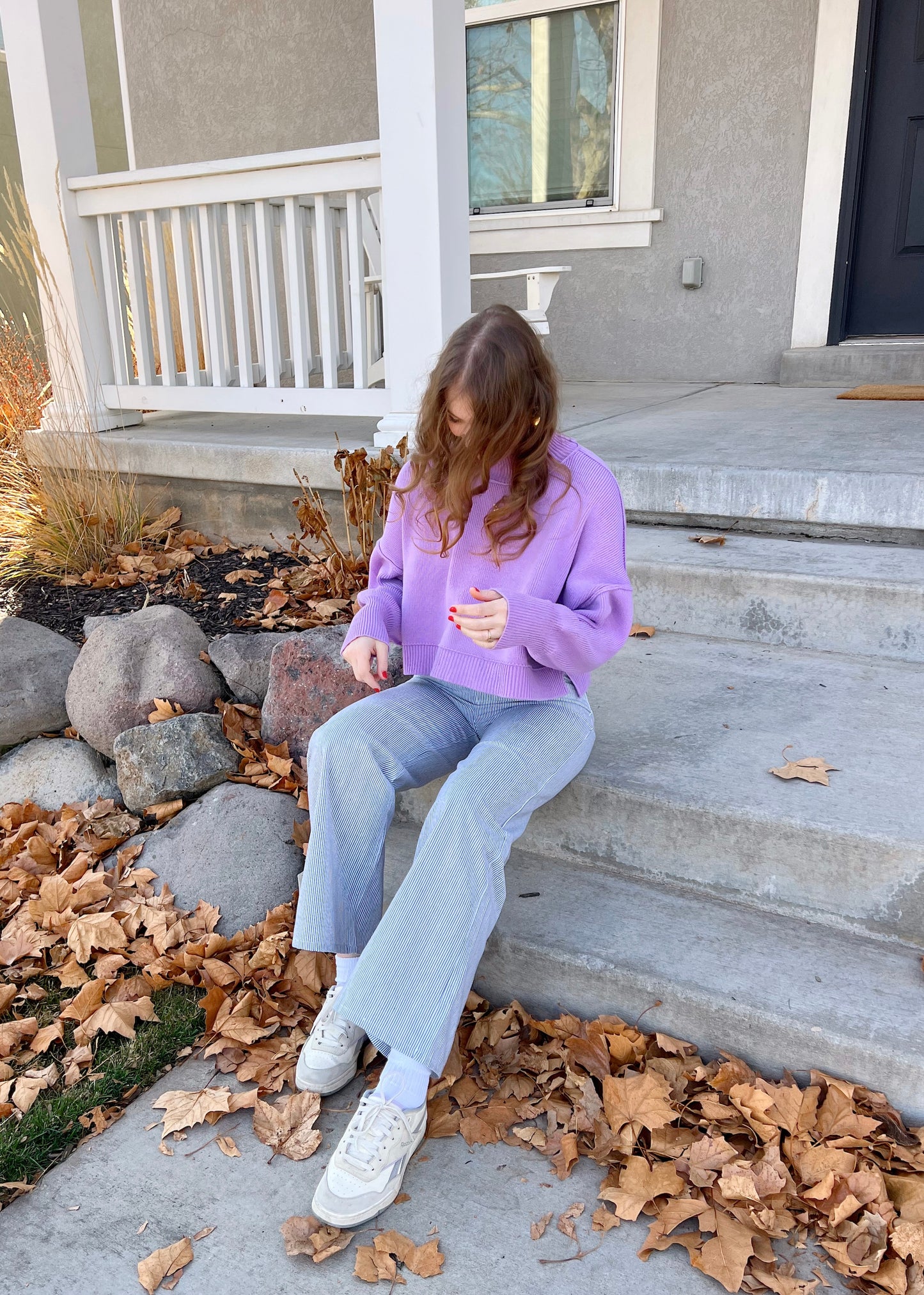 sitting on a bench in coney island pants