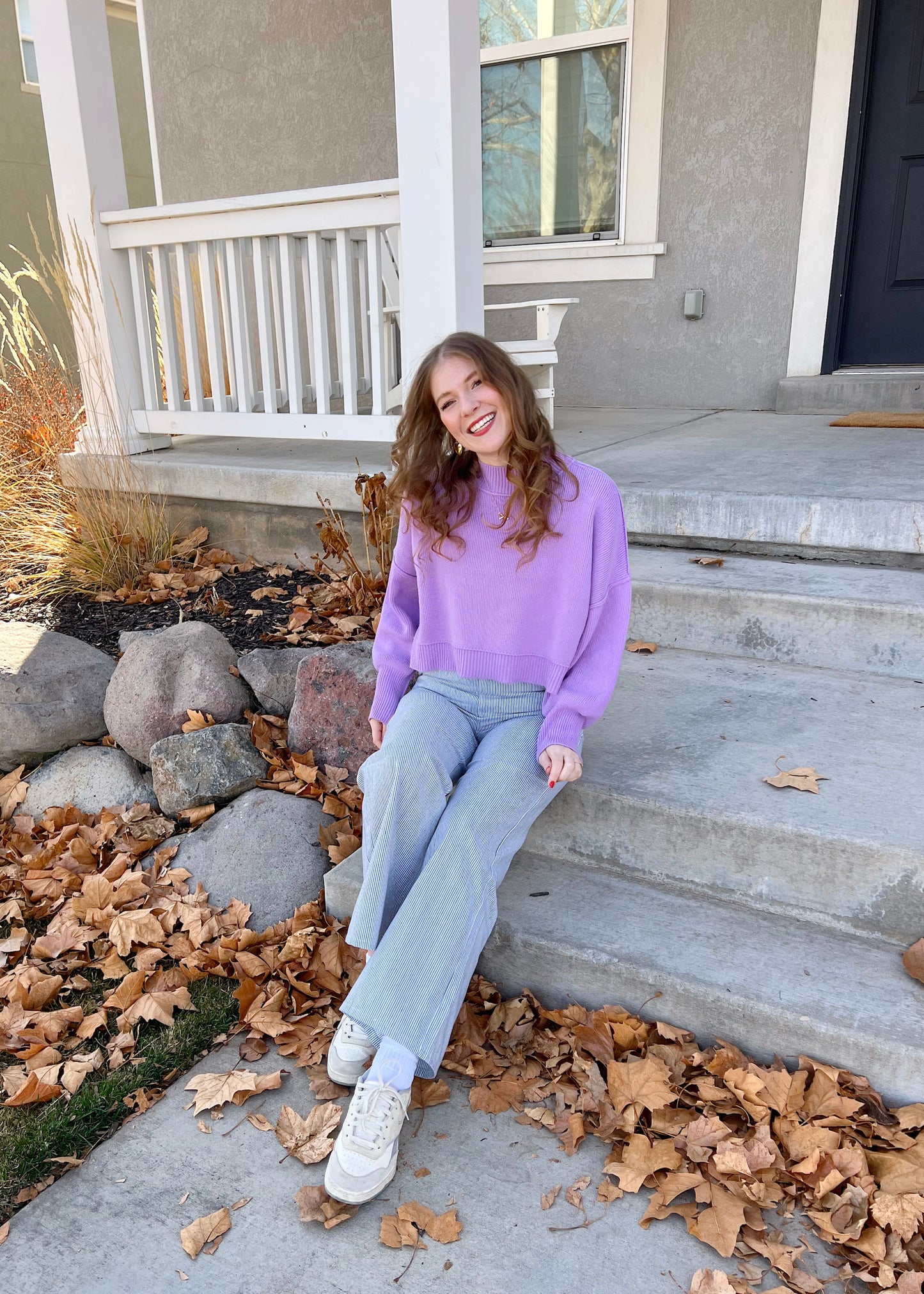 sitting on a bench in coney island pants
