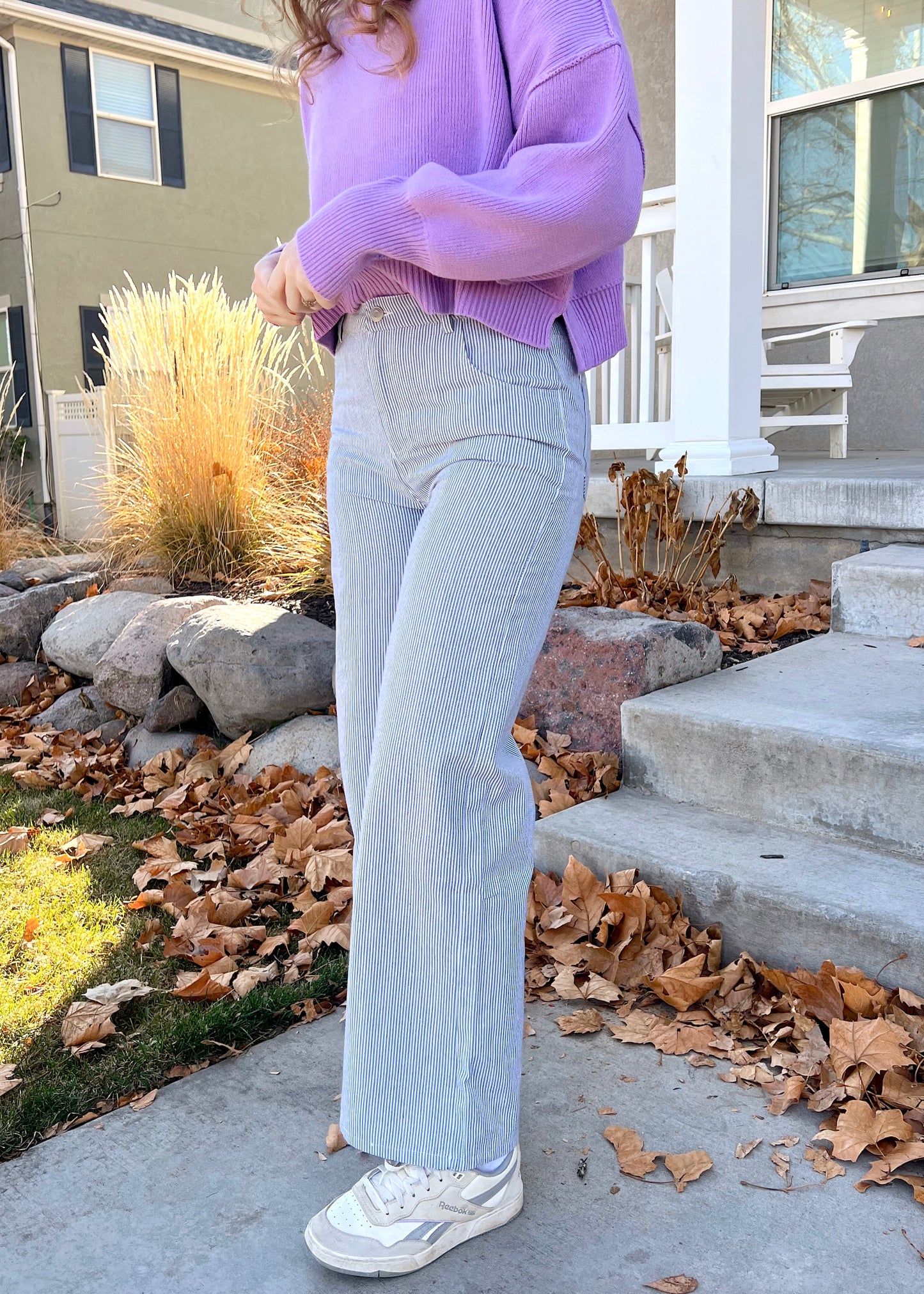 sitting on a bench in coney island pants