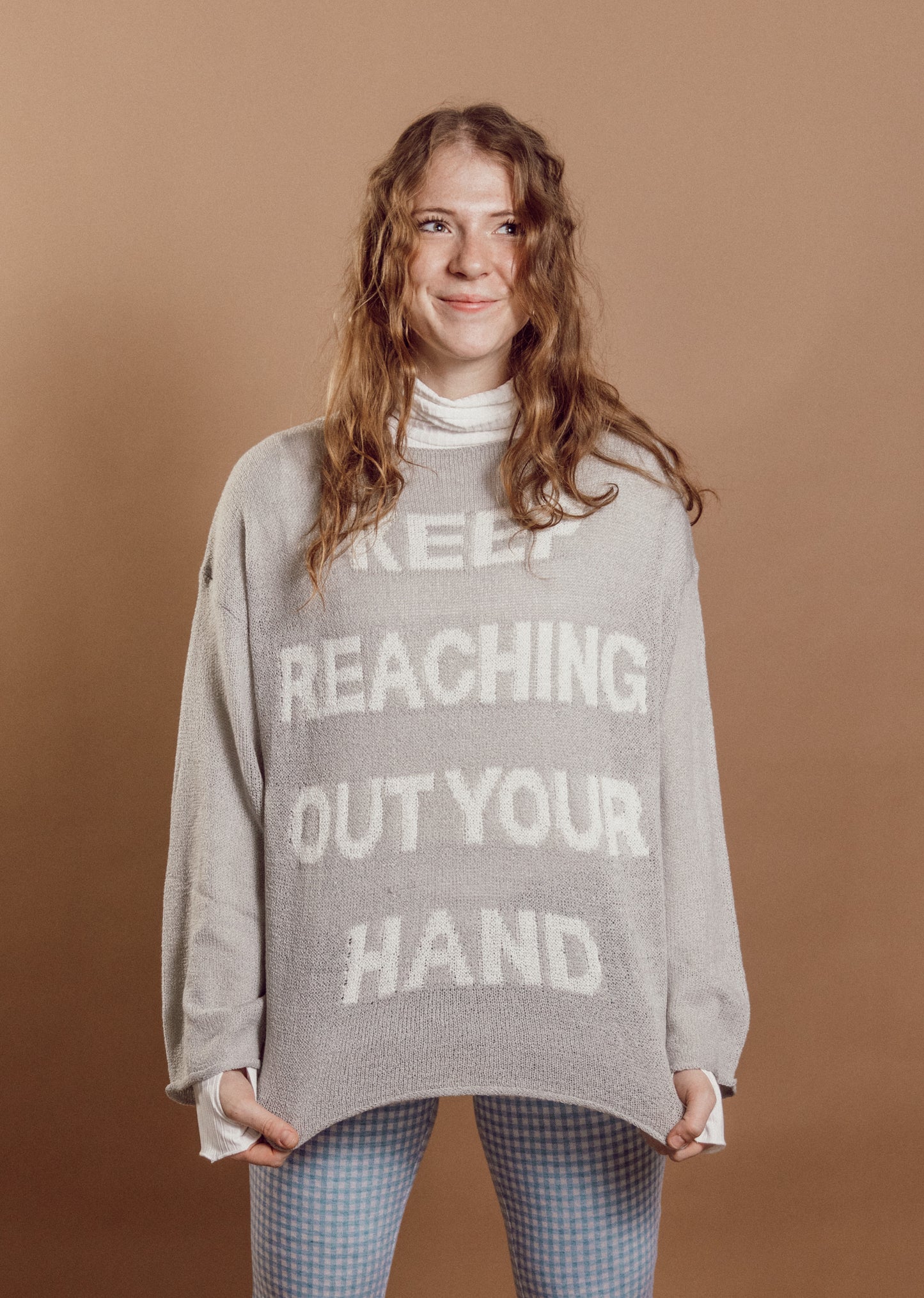 keep reaching out your hand sweater