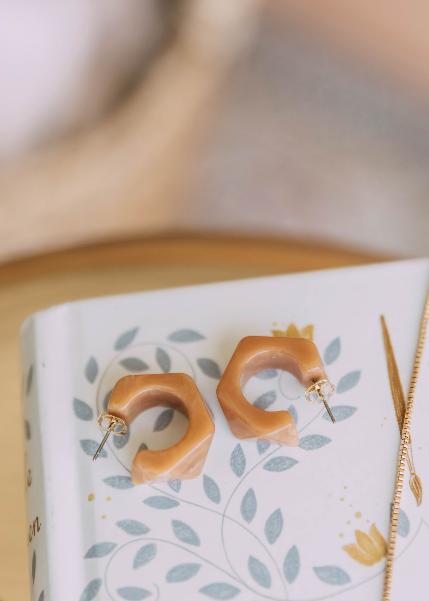 speaking to snakes earrings in peach